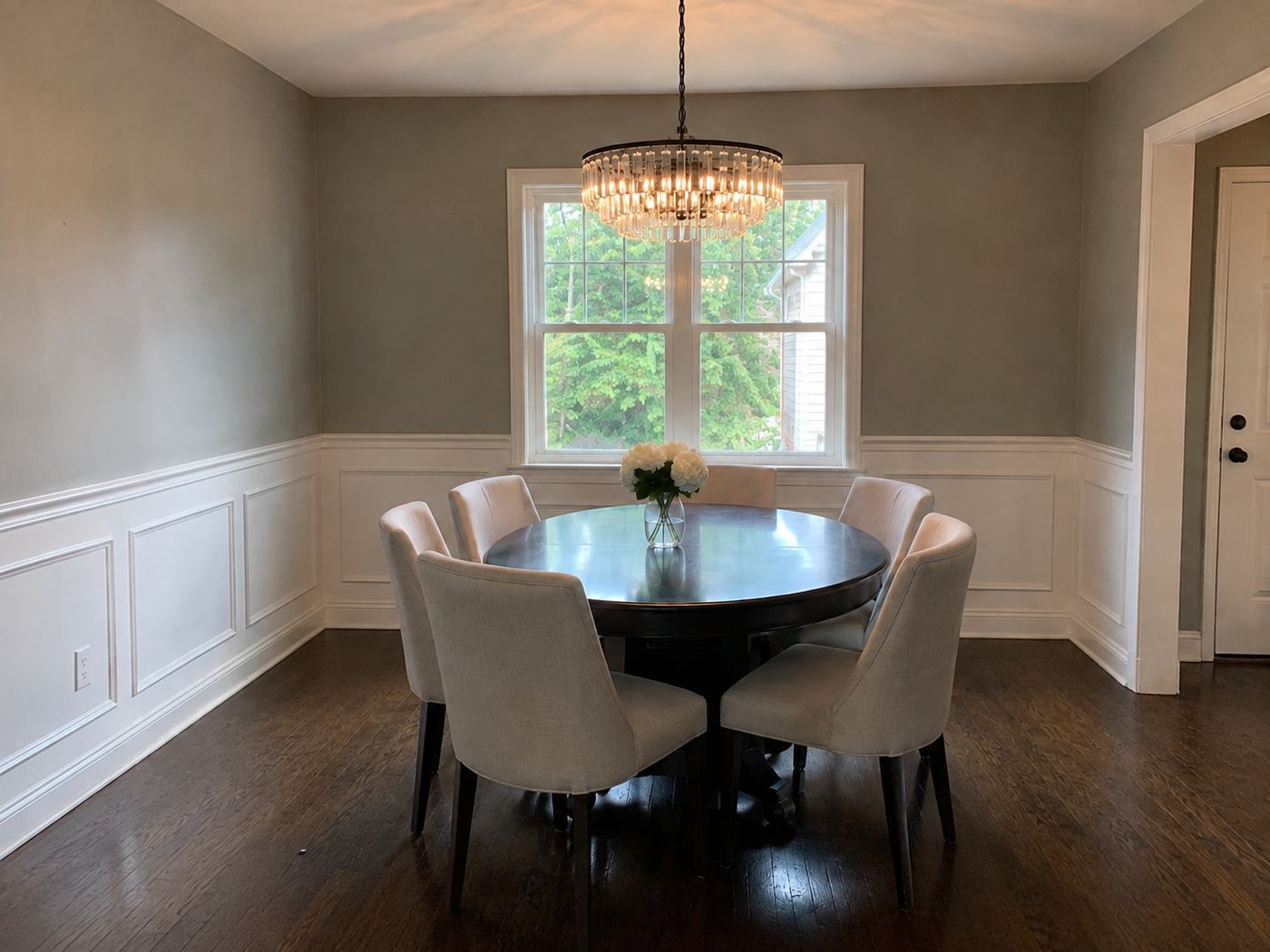 Dining room with wainscoting, crown molding and chandelier