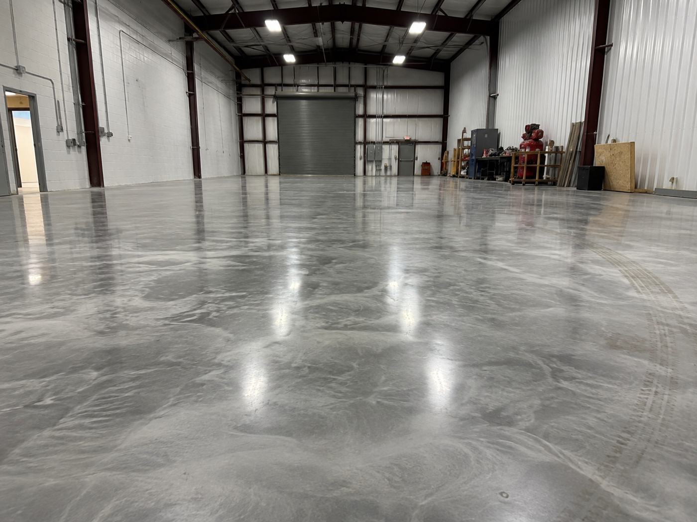 Glossy metallic epoxy floor in an industrial warehouse