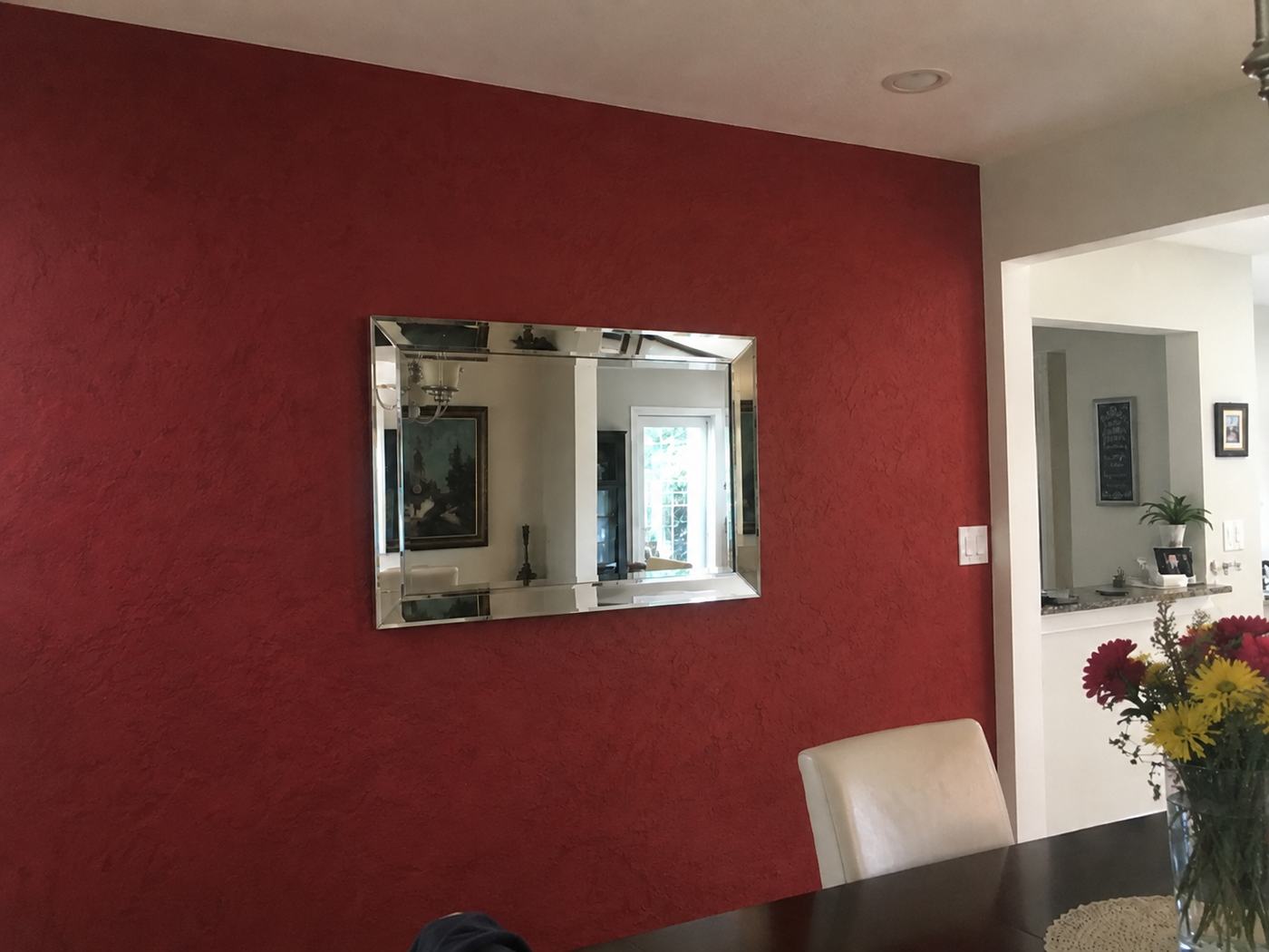 Red Venetian plaster accent wall with mirror
